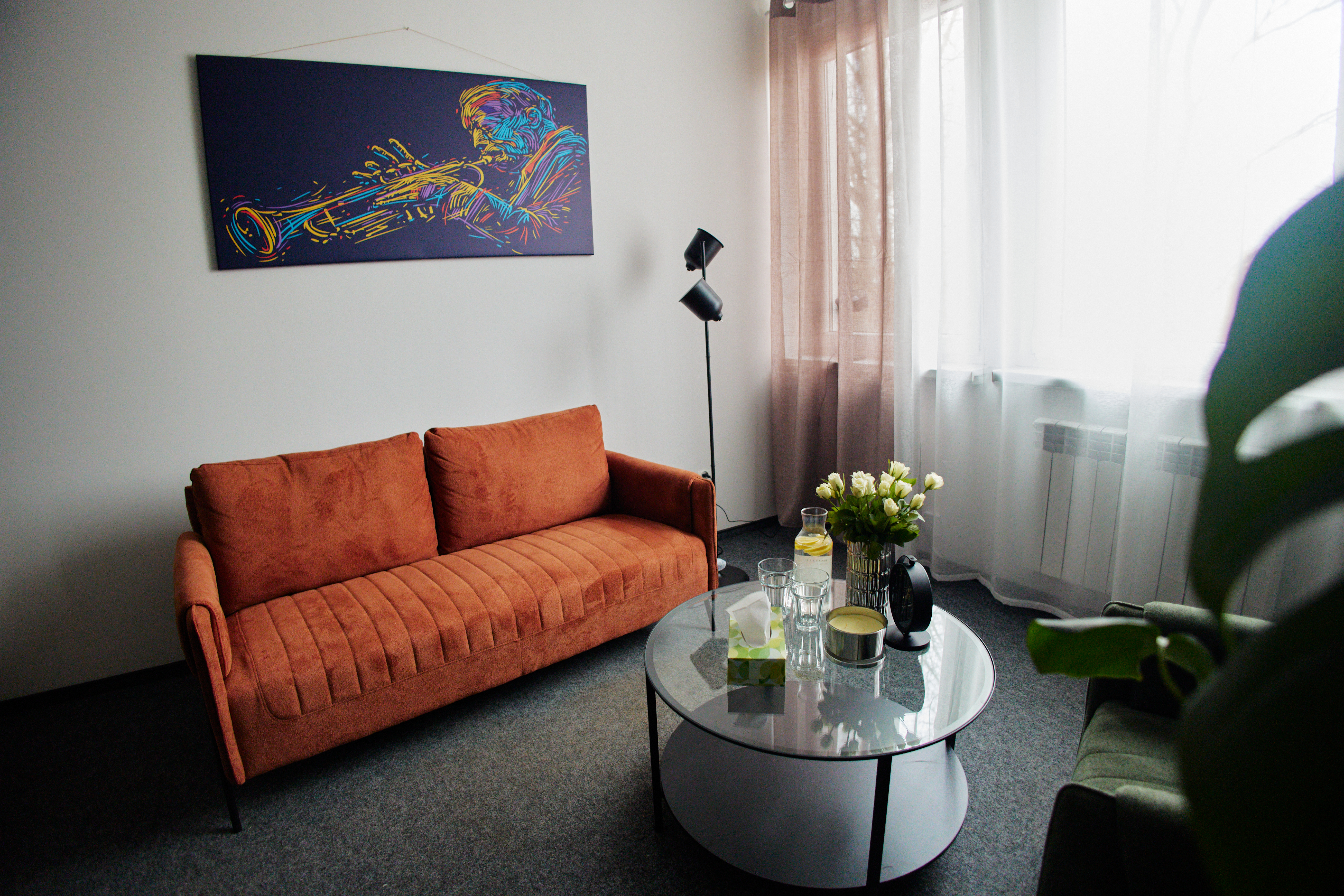 Gabinet terapeutyczny sofa-stół-kwiaty-obraz na ścianie